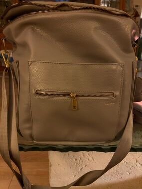 Fawn Design Leather Diaper Bag with adj  straps, pacifier holder, changing pad.